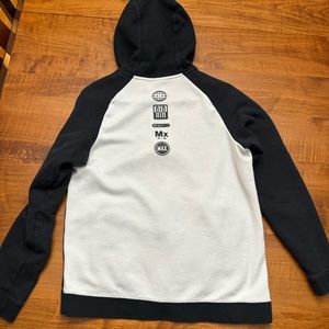 Nike athletic zip up with design on back. Black and White.